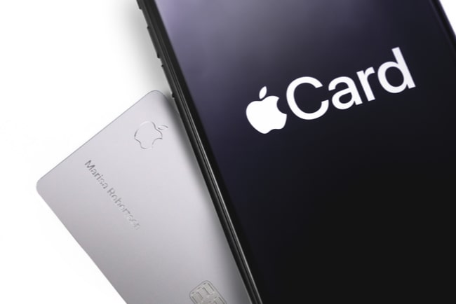 Iphone med apple cards logga och kreditkortet apple card liggandes snett under iphone